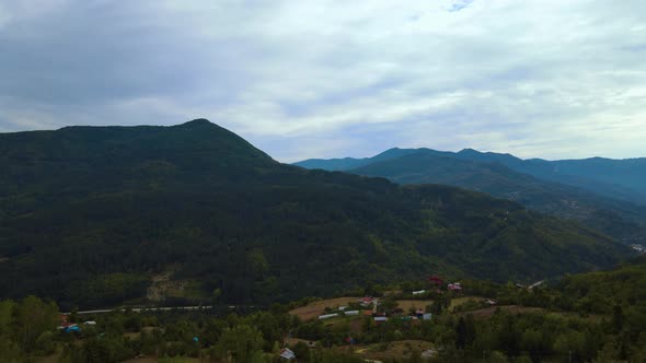 steep green mountains, deep forest and mountain road, beautiful valley  