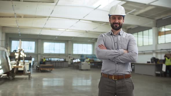 Portrait of Adult Bearded Man Executive Manager or Engineer Wearing Suit and Helmet Monitoring