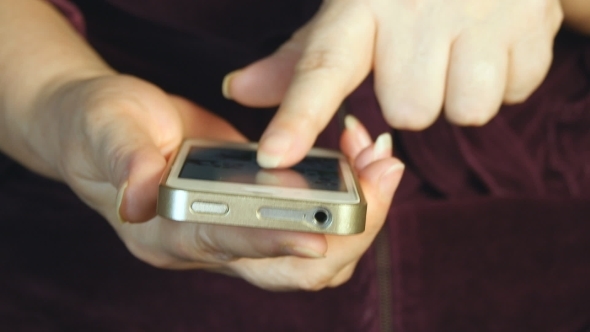 Hands Of The Old Woman And Smartphone.  
