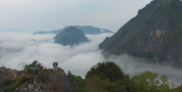 Aerial View Of People On The Top Of Mountain Clouds