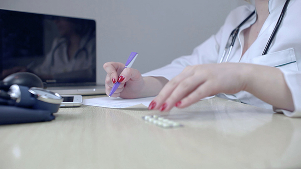 Doctor Fills the Prescription and Provides Medicine