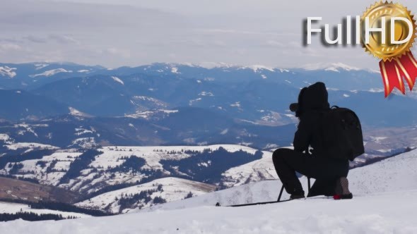 Photographer Taking Landscape Shot in Winter