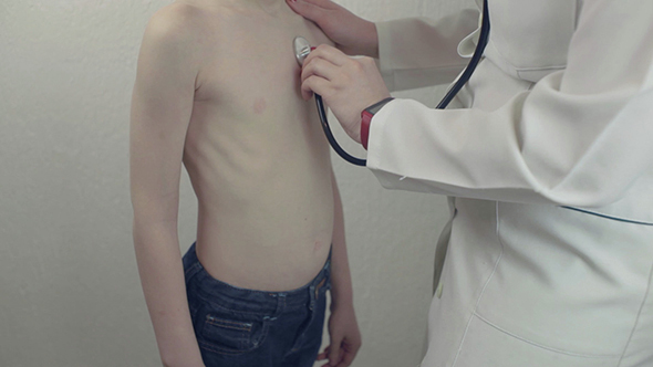Doctor Listens To The Boy With Stethoscope