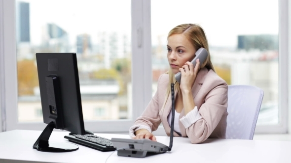 Angry Businesswoman With Computer And Telephone