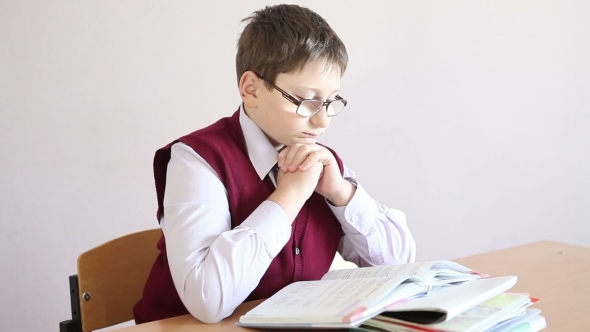 Boy With Glasses Reading a Book 