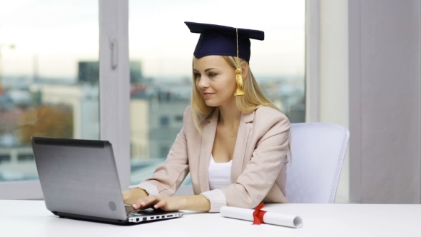 Student In Bachelor Cap With Laptop And Diploma