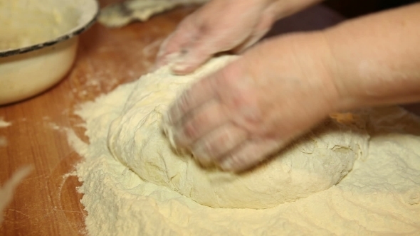 Woman Knead The Dough On The Table