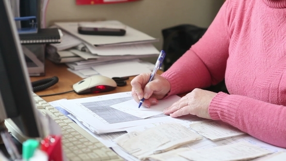 Woman Writes a Note Working In The Office