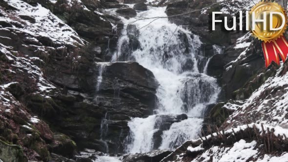 Fast Flowing Water in a Waterfall During Winter