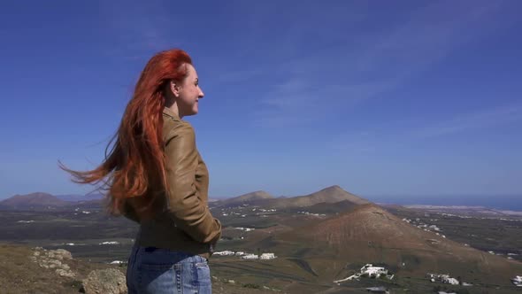 Woman Tourist Admires View From Mountain Top