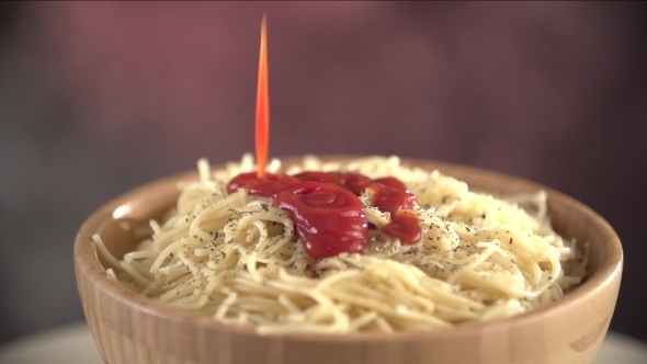 Tomato Sauce Slowly Falls On The Hot Spaghetti Strewed With Seasonings