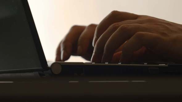 A Human Hands Typing On A Notebook