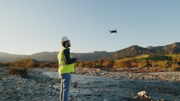 geologist with drone checks the territory