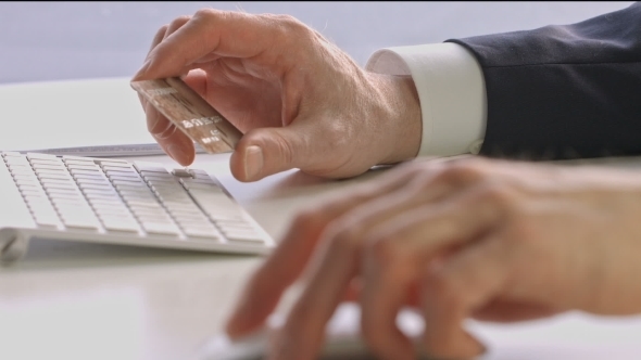 Male Hands Holding Credit Card And Using Mouse alt