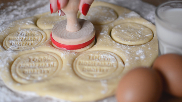 Woman Stamping Rolled out Dough