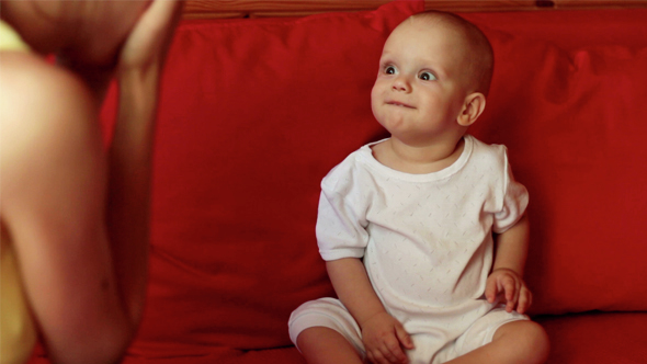 A Little Baby Boy Playing with his Mother alt