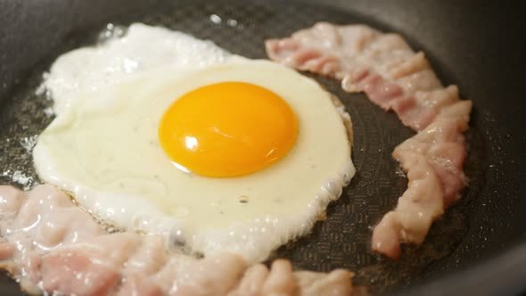 Frying Of An Egg And Bacon