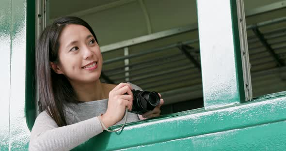 Woman taking photo on camera inside the train