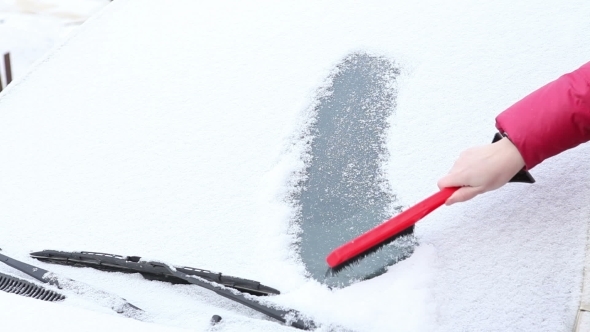 Woman To Clear Snow From The Car Window.