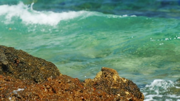 Waves Breaking On Rocks On a Sunny Day