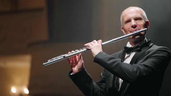 Professional Flutist is Playing Melody in Old Opera House Portrait of Talented Aged Musician