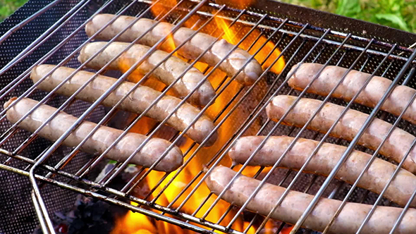 Bratwurst Sausages Cooking On A Wood Barbecue