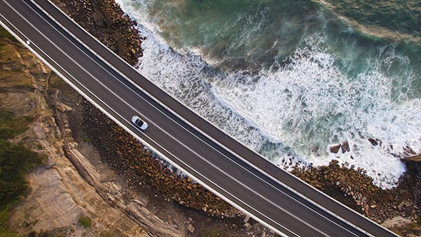 Car Driving across an Ocean Coast Bridge