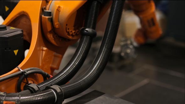 The Robot Arm Performs Work at the Plant