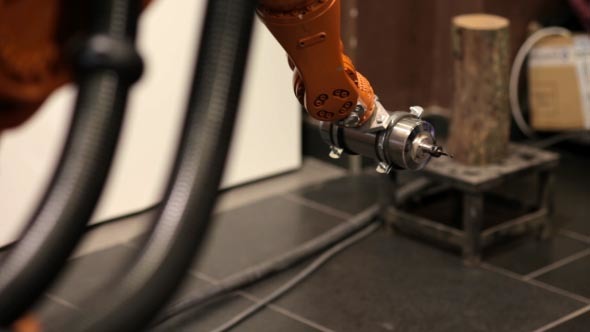 The Robot Arm Performs Work at the Plant