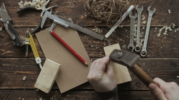 Hammer Head And Nails On a Wooden Table.