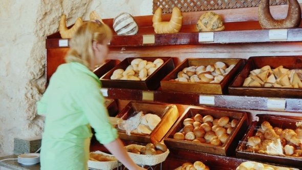 Attractive Woman Chooses Bread At The Cafe With Self-service