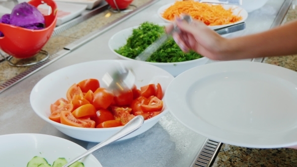 Take The Chopped Tomatoes On The Plate In a Cafe With Self-service