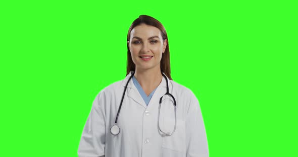 Caucasian female doctor on green screen background