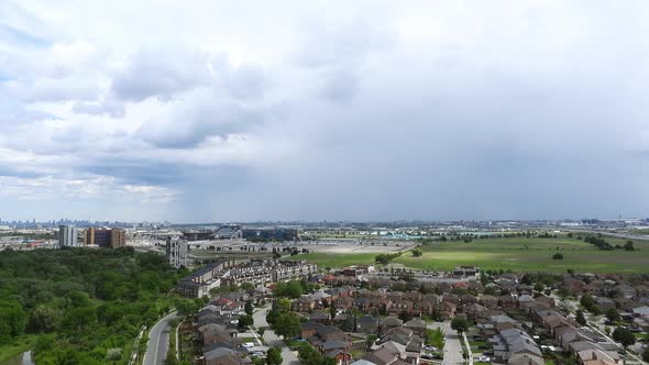 Alternating light and shadow cross the City of Toronto Canada as a huge thunderstorm passes alt