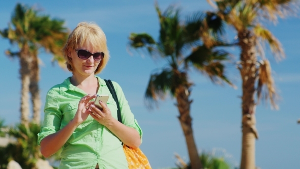 Woman In Summer Clothes Typing On Your Phone