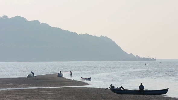 Misty Tropical Seascape With Boats And Fishermen Silhouettes