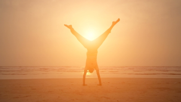 Man Doing Yoga During Sunset On The Beach alt
