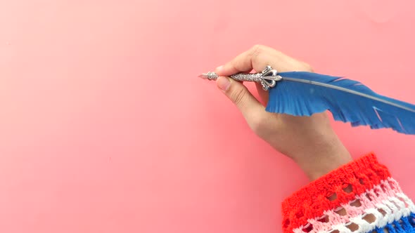 Women Hand Writing with Fountain Pen on Pink Background