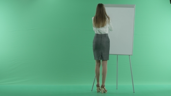 Business Woman Writes On a Whiteboard Deadline On a Green Screen