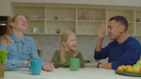 Deaf Parents and School Age Girl with Hearing Loss Chatting with Sign Language