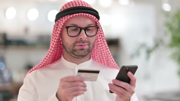 Young Arab Businessman Making Online Payment on Smartphone