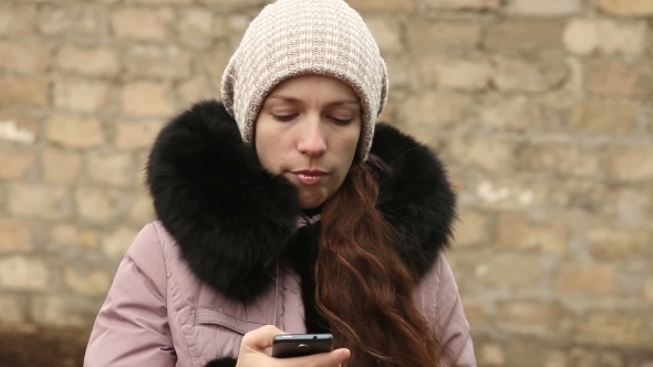 Woman Writing Sms In Winter Clothes On Smartphone