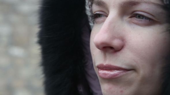 Young Girl In Winter Clothes Chews The Cud