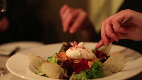 Woman Eating a Salad In a Restaurant 