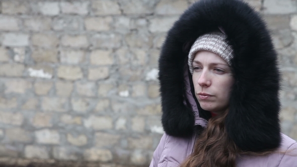 Young Girl In Winter Clothes Chews The Cud