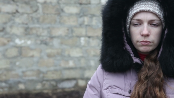 Young Girl In Winter Clothes Chews The Cud