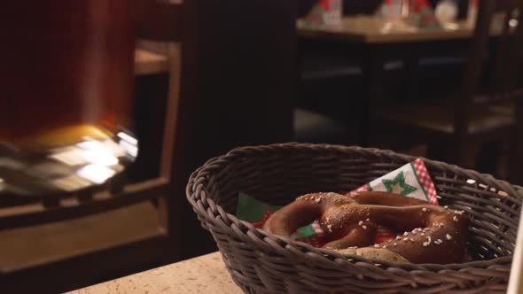 Hand drinking from a beer and a bretzel in Germany.