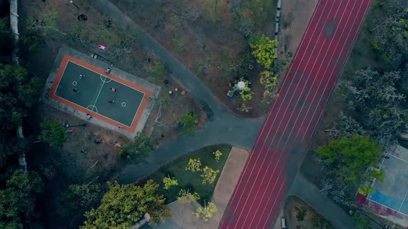 Running Track By Playground Between Forest and Court