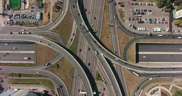 Aerial drone view of highway multi-level junction road with moving cars