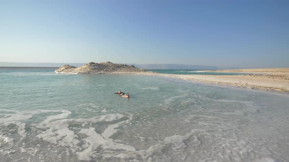 Girl Is Relaxing And Swimming In Water Of Dead Sea In Israel